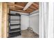 Interior of storage room with wooden framing, concrete flooring and a shelving unit at 1259 Vanderbilt Dr, Ormond Beach, FL 32174