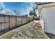 View of the backyard, enclosed by a tall wooden fence, offering a private and secure outdoor space at 129 S Marydell Ave, Deland, FL 32720