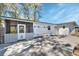 A cozy outdoor space with a screened patio, concrete pad and simple landscaping elements at 129 S Marydell Ave, Deland, FL 32720