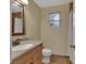 Bathroom featuring tile flooring, window and wood vanity with mirror at 129 S Marydell Ave, Deland, FL 32720