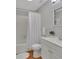 Cozy bathroom with white shower curtain, white vanity, toilet and neutral gray walls at 129 S Marydell Ave, Deland, FL 32720