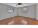 Spacious bedroom features hardwood floors, ceiling fan and two windows at 129 S Marydell Ave, Deland, FL 32720