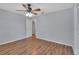 Neutral bedroom featuring a ceiling fan, wood floors, and closet for a clean, comfortable space at 129 S Marydell Ave, Deland, FL 32720