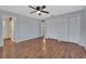 Large bedroom features wood floors, two closets, and neutral gray walls at 129 S Marydell Ave, Deland, FL 32720