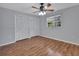 Neutral bedroom with wood floors, two white closets, and window with natural light at 129 S Marydell Ave, Deland, FL 32720