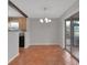 Cozy dining area with terracotta tile flooring, adjacent to the kitchen and featuring sliding door access to patio at 129 S Marydell Ave, Deland, FL 32720