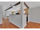 Open-concept kitchen featuring terracotta tile floors, a breakfast bar, and seamless access to adjacent rooms at 129 S Marydell Ave, Deland, FL 32720