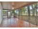 The home features a covered, screened patio with tile floors and backyard access at 129 S Marydell Ave, Deland, FL 32720