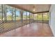Large, airy screened patio with tile flooring, perfect for enjoying the outdoors in comfort at 129 S Marydell Ave, Deland, FL 32720