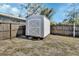 Backyard shows a white storage shed against a wooden fence, providing extra storage space at 129 S Marydell Ave, Deland, FL 32720