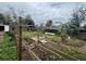 Large backyard featuring raised garden beds and an assortment of vegetation at 1341 Imperial Dr, Daytona Beach, FL 32117