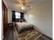 Cozy bedroom with wood floors, a ceiling fan, and a large window at 1341 Imperial Dr, Daytona Beach, FL 32117