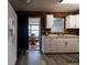 Galley kitchen features white cabinets, stainless appliances, and views to the sunroom at 1341 Imperial Dr, Daytona Beach, FL 32117