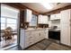 Bright galley kitchen features white cabinets, stainless appliances and views to the sunroom at 1341 Imperial Dr, Daytona Beach, FL 32117