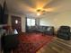 Cozy living room with hardwood floors, an area rug, and a ceiling fan at 1341 Imperial Dr, Daytona Beach, FL 32117
