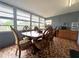 Bright sunroom with a mosaic tile floor, dining set, and many windows at 1341 Imperial Dr, Daytona Beach, FL 32117