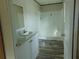 Well-lit bathroom showcasing a vanity with a granite-look countertop and a shower with a white surround at 1367 Vine St, Daytona Beach, FL 32117