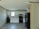 Spacious kitchen featuring black appliances, white cabinets, and stylish floors at 1367 Vine St, Daytona Beach, FL 32117