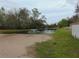 Scenic view of pond with fountain surrounded by lush greenery, creating a peaceful backyard oasis at 1367 Vine St, Daytona Beach, FL 32117