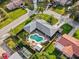 Aerial view of a home with a pool and lush landscaping in a suburban neighborhood at 1424 Breaks Way, Port Orange, FL 32127