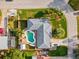 Aerial view of a home with a pool, boat, and neatly maintained landscaping in a suburban neighborhood at 1424 Breaks Way, Port Orange, FL 32127