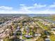 An aerial view of a home set in a neighborhood, close to the water and a distant city at 1424 Breaks Way, Port Orange, FL 32127
