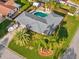 Aerial view of a home with a well-manicured lawn, complemented by a pool and a boat in the driveway at 1424 Breaks Way, Port Orange, FL 32127