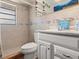 This bathroom boasts tiled walls, a shower, a toilet, and a vanity sink for convenience at 1424 Breaks Way, Port Orange, FL 32127