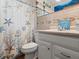 This bathroom offers a toilet, vanity sink, and a decorative shower curtain, creating a functional space at 1424 Breaks Way, Port Orange, FL 32127