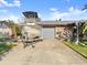Exterior view of a brick home with a boat on the driveway, showcasing its convenient location and amenities at 1424 Breaks Way, Port Orange, FL 32127
