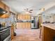 Open kitchen design with oak cabinets, stainless appliances, and view into the living space at 1424 Breaks Way, Port Orange, FL 32127