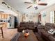 Relaxing living room featuring dual leather couches, leading to a kitchen space at 1424 Breaks Way, Port Orange, FL 32127