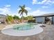 Gorgeous backyard featuring a pool, stone patio, privacy fence, and lush tropical landscaping at 1424 Breaks Way, Port Orange, FL 32127