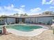 Backyard patio with a sparkling pool surrounded by stone pavers, seating area, and easy access to the home at 1424 Breaks Way, Port Orange, FL 32127