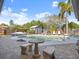 Backyard pool area with outdoor seating, mature palm trees and shed at 1424 Breaks Way, Port Orange, FL 32127