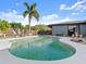 Beautiful pool surrounded by a spacious patio, palm tree, and lush landscaping for a private oasis at 1424 Breaks Way, Port Orange, FL 32127