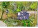 Birds-eye view of the property showcasing the home, large lot, mature trees, and convenient street access at 1702 Carolina Ave, Ormond Beach, FL 32174