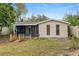Back exterior of home includes a screened-in porch, fenced in yard and exterior shed for extra storage at 1702 Carolina Ave, Ormond Beach, FL 32174