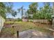 Fenced backyard offering a storage shed, mature trees, and potential for landscaping and outdoor activities at 1702 Carolina Ave, Ormond Beach, FL 32174