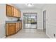 Cozy kitchen area featuring tile floors and a view of the screened in porch at 1702 Carolina Ave, Ormond Beach, FL 32174