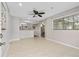 Open-concept living room with tile floors, ceiling fan, and view of dining area at 1702 Carolina Ave, Ormond Beach, FL 32174