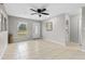Bright living room with tile floors, ceiling fan, and front door at 1702 Carolina Ave, Ormond Beach, FL 32174