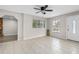 Inviting living room featuring tile floors, large windows, and ceiling fan at 1702 Carolina Ave, Ormond Beach, FL 32174