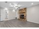 Cozy living room with beautiful stone fireplace and modern gray flooring at 1702 Carolina Ave, Ormond Beach, FL 32174