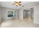 Bright, open living room with tile floors and access to a screened lanai through sliding glass doors at 1702 Carolina Ave, Ormond Beach, FL 32174