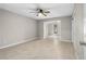 Inviting living room with tile floors, ceiling fan, and open archway to another living space at 1702 Carolina Ave, Ormond Beach, FL 32174