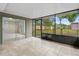 Enclosed screened porch with tile flooring, sliding glass doors, and a view of the backyard at 1702 Carolina Ave, Ormond Beach, FL 32174