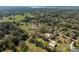 An aerial view showcases the expansive property surrounded by lush greenery at 1773 Blue Oak Ct, Deland, FL 32720
