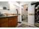 Classic bathroom with wood cabinets, neutral tile and ample storage at 1773 Blue Oak Ct, Deland, FL 32720