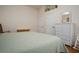 Bedroom with an accent for flower vases above a wall mirror and two closet doors with a bench below them at 1773 Blue Oak Ct, Deland, FL 32720